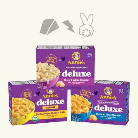 Annies Deluxe Shells & White Cheddar, Deluxe Shells & Vegan Cheddar Style and Deluxe Shells & Classic Cheddar, front of boxes stacked on top of each other in a pyramid with bunny graphics on a off white background.